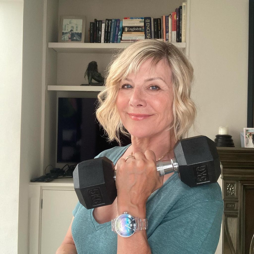 Woman holding a weight and smiling 